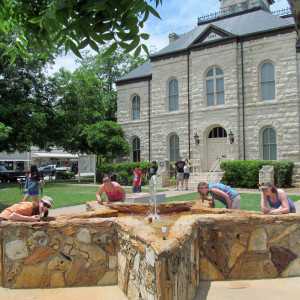 My camping buddies and me drinking from a Lone Star-shaped water fountain outside the courthouse as the rain dissipated